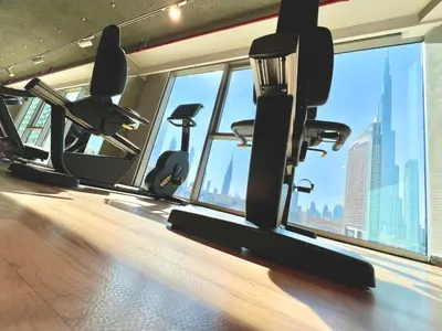 a gym with a view of the city at Downtown Views 1BR - Dubai Mall, Fountain & Burj Khalifa access in Dubai