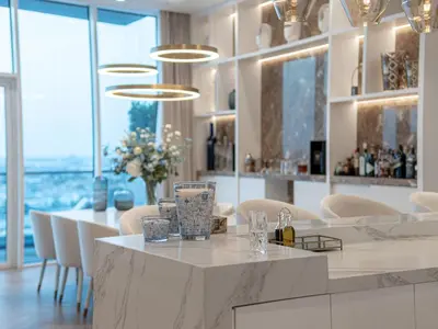 a dining room with a table and chairs and windows at Daniels Sea View 2BR in Oceana The Palm Jumeirah in Dubai