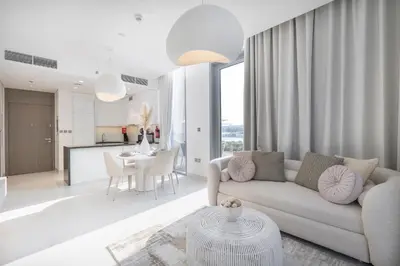 a living room with a couch and a table at Crystal water lagoon living in District One in Dubai