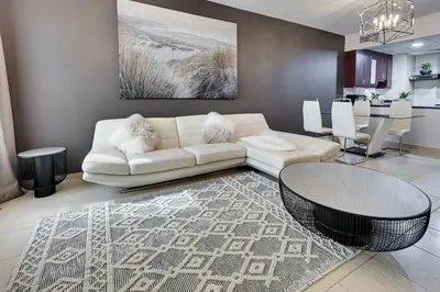 a living room with a white couch and a table at Studio sea view in Dubai