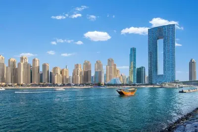 a boat in the water in front of a city at Studio sea view in Dubai