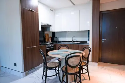 a kitchen with a table and chairs in a room at Elegant 1bedroom in J ONE in Dubai
