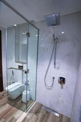 a bathroom with a shower with a toilet and a sink at Elegant 1bedroom in J ONE in Dubai