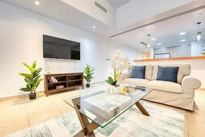 a living room with a couch and a glass table at Direct Access to Nakheel Mall At the Heart of The Palm in Dubai