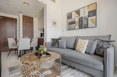 a living room with a couch and a table at Frank Porter - Vera Residence in Dubai