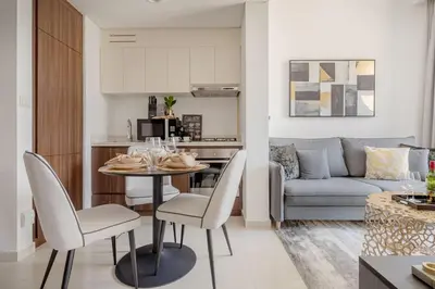 a kitchen and living room with a table and chairs at Frank Porter - Vera Residence in Dubai