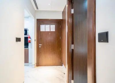 a hallway with a wooden door in a building at New Arabian 2 Bedroom J One Tower Business Bay in Dubai