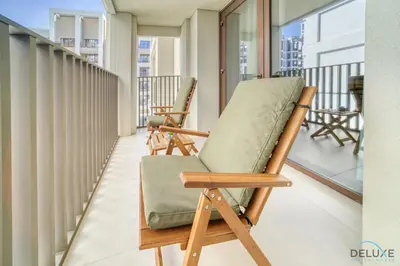 two rocking chairs sitting on a balcony at Capacious 2BR at Sunset at Creek Beach 3 Dubai Creek Harbor by Deluxe Holiday Homes in Dubai