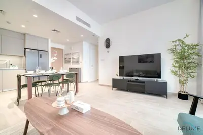 a large living room with a table and a tv at Capacious 2BR at Sunset at Creek Beach 3 Dubai Creek Harbor by Deluxe Holiday Homes in Dubai