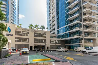 a large building with cars parked in front of it at Perfect 2BD apartment in the heart of Marina - top spot in Dubai