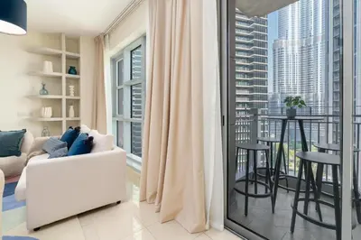 a living room with a white couch and a large window at Burj Khalifa Views / 5 min walk from Dubai Mall / Dubai Opera / Upgraded / Designer Choice / 8 people / The Best Location in Dubai