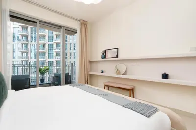 a bedroom with a white bed and a large window at Burj Khalifa Views / 5 min walk from Dubai Mall / Dubai Opera / Upgraded / Designer Choice / 8 people / The Best Location in Dubai