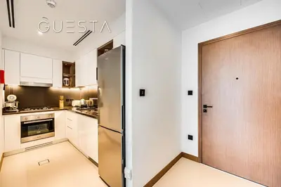 a kitchen with a stainless steel refrigerator and a door at Vida Residences Dubai Marina by Emaar in Dubai