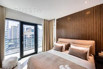 a bedroom with a large bed and a large window at Vida Residences Dubai Marina by Emaar in Dubai