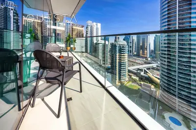 a chair on a balcony with a view of a city at Vida Residences Dubai Marina by Emaar in Dubai