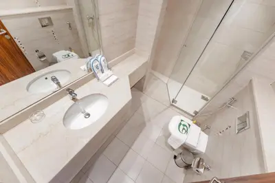 a bathroom with a sink and a shower at Studio in Reef Residence JVC by PK Holidays in Dubai