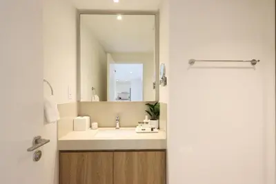 a bathroom with a sink and a large mirror at Livbnb Suites - Lavish 2BR w/ Burj Khalifa Views & Near Dubai Mall in Dubai