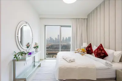 a bedroom with a large bed and a mirror at Livbnb Suites - Lavish 2BR w/ Burj Khalifa Views & Near Dubai Mall in Dubai