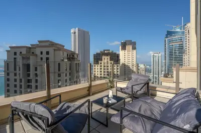 a balcony with chairs and a view of the city at GuestReady - Seaview residence in Dubai Marina in Dubai