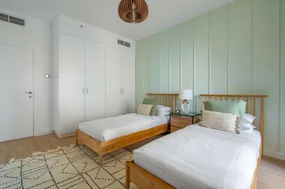 a bedroom with two beds and a rug at GuestReady - Seaview residence in Dubai Marina in Dubai
