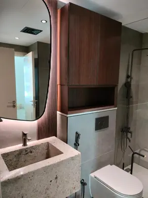 a bathroom with a sink and a toilet and a mirror at Modern-Chic 1BR in The Greens - Central Dubai in Dubai