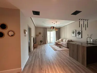 a living room with a couch and a table in a room at Modern-Chic 1BR in The Greens - Central Dubai in Dubai