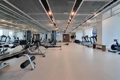 a gym with treadmills and exercise equipment in a building at *Private Beach* Best Ocean View Emaar BeachFront in Dubai