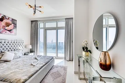 a bedroom with a bed and a large mirror at Emaar Beachfront Sunrise Bay 2bdr apartment in Dubai