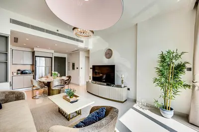 a living room with a couch and a table at Emaar Beachfront Sunrise Bay 2bdr apartment in Dubai