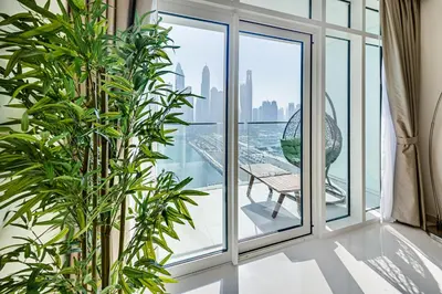 a room with a window with a view of the city at Emaar Beachfront Sunrise Bay 2bdr apartment in Dubai
