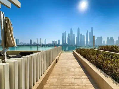 a walkway with a view of the dubai skyline at Emaar Beachfront Sunrise Bay 2bdr apartment in Dubai
