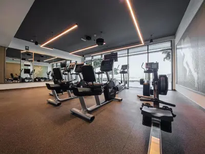 a gym with cardio equipment in a large room at Emaar Beachfront Beach Vista 3bdr apartment in Dubai