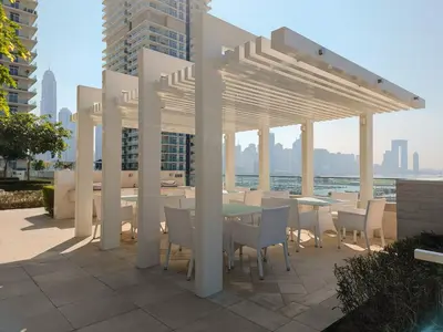 a patio with a table and chairs under a pavilion at Emaar Beachfront Beach Vista 3bdr apartment in Dubai