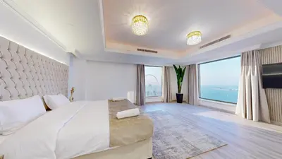 a bedroom with a large bed and large windows at Huge Penthouse with yacht included and private pool!!! in Dubai