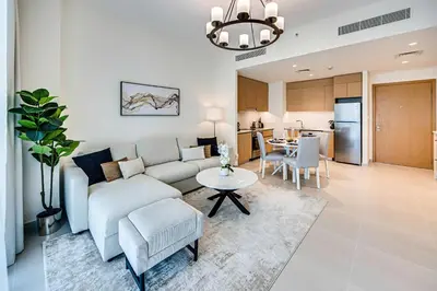 a living room with a couch and a table at Nice 1BD Apartment in Surf at Creek Beach in Dubai
