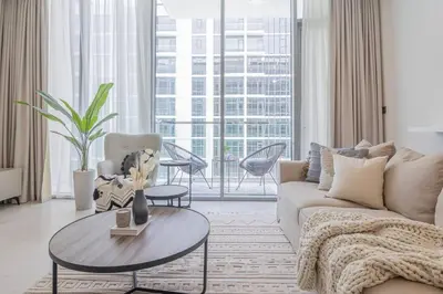 a living room with a couch and a table at HiGuests - Step Into Heaven In This Lakeside Apartment in Dubai