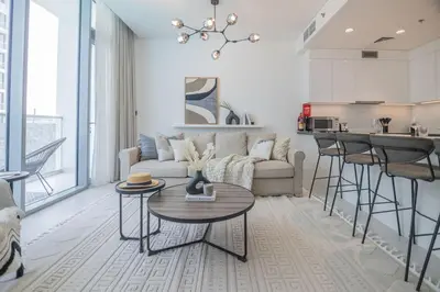 a living room with a couch and a table at HiGuests - Step Into Heaven In This Lakeside Apartment in Dubai