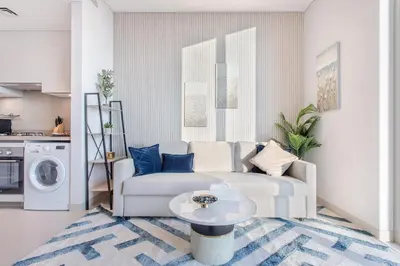 a living room with a couch and a table at STAY BY LATINEM Luxury 1BR Holiday Home CVR A413 near Burj Khalifa in Dubai