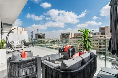 a balcony with couches and a view of a city at Guestready - Grey Pearl with Big Balcony in Dubai
