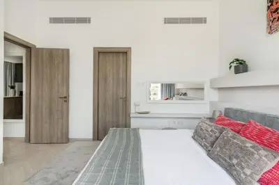 a bedroom with a bed and a living room at Guestready - Grey Pearl with Big Balcony in Dubai