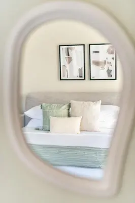 a bedroom with a bed with three framed pictures at GuestReady - Lux living with an infinity pool in Dubai