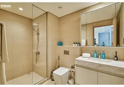 a bathroom with a shower and a toilet and a sink at bnbme - Chic 1BR Apt w Balcony Pool Gym Access Steps to Burj Khalifa & Dubai Mall in Dubai