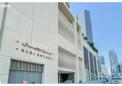a building with a sign on the side of it at bnbme - Chic 1BR Apt w Balcony Pool Gym Access Steps to Burj Khalifa & Dubai Mall in Dubai