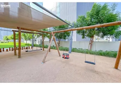 an empty playground with swings in a building at bnbme - Chic 1BR Apt w Balcony Pool Gym Access Steps to Burj Khalifa & Dubai Mall in Dubai
