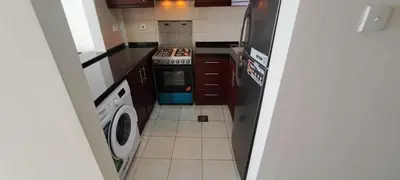 a small kitchen with a stove and a dishwasher at DRUVYA HOLIDAY HOMES, Bld DG083, Street No,3 Discovery Gardens, Close to The Gardens Metro 6 minutes walkable in Dubai