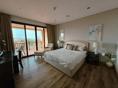 a bedroom with a bed and a balcony at Family friendly apt at Palm in Dubai