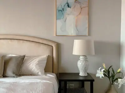 a bedroom with a bed and a table with a lamp at Family friendly apt at Palm in Dubai