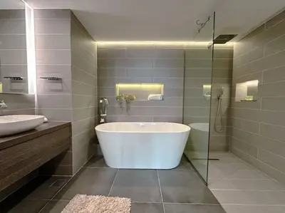 a bathroom with a tub and a sink and a shower at Family friendly apt at Palm in Dubai