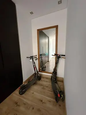 two scooters parked in a room with a mirror at Family friendly apt at Palm in Dubai