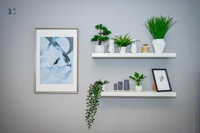 a white wall with shelves with plants and a picture at Luxury Escapes - Stylish 1BR Apartment - Close to Metro in Dubai Marina - Cascade Tower in Dubai